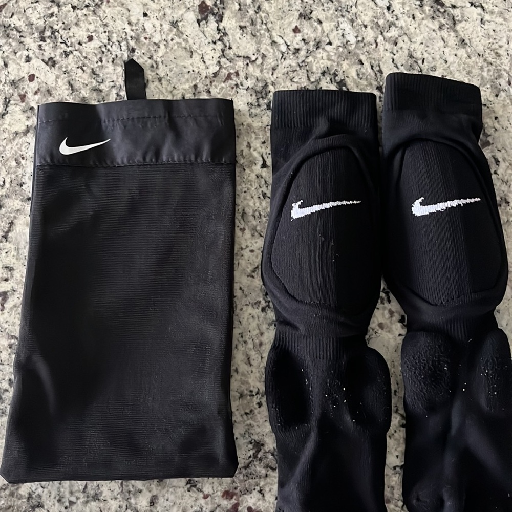 Used Nike boys XS soccer socks with shin guards- bag included!